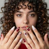 latina female with curly wavy hair Nutcracker-inspired Christmas nail art, nail close up